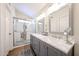 Bathroom features a modern glass-enclosed shower and double vanity sinks with framed mirrors at 9085 E Windrose Dr, Scottsdale, AZ 85260
