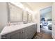 Bathroom with double sinks, framed mirrors and white marble countertops next to the primary bedroom at 9085 E Windrose Dr, Scottsdale, AZ 85260