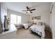 Cozy bedroom with a ceiling fan, two beds and large windows at 9085 E Windrose Dr, Scottsdale, AZ 85260
