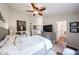 A spacious bedroom with wood-look flooring, a TV, and an ensuite bathroom, creating a relaxing retreat at 9085 E Windrose Dr, Scottsdale, AZ 85260