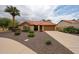 Charming home with mature landscaping, decorative stone, and a spacious driveway at 9085 E Windrose Dr, Scottsdale, AZ 85260