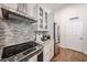 Modern kitchen features stainless steel appliances, granite countertops, and ample cabinet space at 9085 E Windrose Dr, Scottsdale, AZ 85260