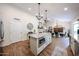Kitchen island with a built-in microwave and a view of the fireplace and dining area at 9085 E Windrose Dr, Scottsdale, AZ 85260