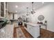 Spacious kitchen with white cabinets, granite countertops, stainless steel appliances, and an island at 9085 E Windrose Dr, Scottsdale, AZ 85260