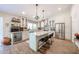 Bright, open kitchen with large island, stainless steel appliances, wine cooler and custom cabinetry at 9085 E Windrose Dr, Scottsdale, AZ 85260