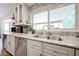 Close-up of the kitchen sink with granite countertops and a view of the outside at 9085 E Windrose Dr, Scottsdale, AZ 85260