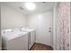 Bright laundry room features a washer, dryer, and door at 9085 E Windrose Dr, Scottsdale, AZ 85260