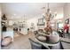 Open-concept living space with a dining area, kitchen, and fireplace at 9085 E Windrose Dr, Scottsdale, AZ 85260
