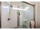 Shower featuring a glass enclosure, showerhead and tiled walls at 9085 E Windrose Dr, Scottsdale, AZ 85260
