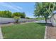 Expansive backyard featuring a lush green lawn, gravel landscaping, refreshing pool, and ample space for recreation at 9450 N 83Rd Pl, Scottsdale, AZ 85258