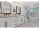 Elegant bathroom with double vanity, soaking tub, and glass-enclosed shower at 9450 N 83Rd Pl, Scottsdale, AZ 85258