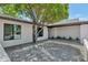 Private courtyard featuring a large tree, sleek, modern architecture, and a beautiful paved patio at 9450 N 83Rd Pl, Scottsdale, AZ 85258