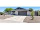 Modern single-story home featuring a spacious driveway and well-kept landscaping, with updated neutral colors at 9450 N 83Rd Pl, Scottsdale, AZ 85258