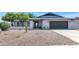 Charming home with a well-maintained gravel front yard, modern exterior paint, and a spacious two-car garage at 9450 N 83Rd Pl, Scottsdale, AZ 85258