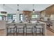 Bright kitchen island with seating, stainless steel appliances, and view of the backyard at 9450 N 83Rd Pl, Scottsdale, AZ 85258