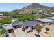 Areal view of home showcasing lush landscaping, a covered parking area, and mountain views at 9520 N Central Ave, Phoenix, AZ 85020