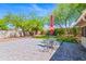 Beautiful backyard with manicured lawn, desert landscaping, brick pavers, and patio with umbrella at 9520 N Central Ave, Phoenix, AZ 85020