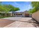 Spacious backyard featuring grass, paved patio, a dining table and mature trees, ideal for outdoor entertainment at 9520 N Central Ave, Phoenix, AZ 85020