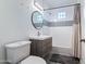 Bathroom with sleek vanity, contemporary fixtures, shower-tub combination with subway tile and glass blocks at 9520 N Central Ave, Phoenix, AZ 85020