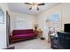 Bright bedroom features ceiling fan, natural light, wood-look tile floors, and white shuttered windows at 9520 N Central Ave, Phoenix, AZ 85020