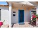 Close up of a blue front door with brickwork, pillars and bougainvillea at 9520 N Central Ave, Phoenix, AZ 85020