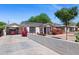 Quaint white house with lush bougainvillea, a carport, and a desert-style yard at 9520 N Central Ave, Phoenix, AZ 85020