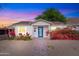 Charming white brick home with a vibrant blue door and beautiful bougainvillea bushes at 9520 N Central Ave, Phoenix, AZ 85020