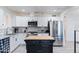Well-appointed kitchen with white cabinetry, stainless steel appliances, and a central island at 9520 N Central Ave, Phoenix, AZ 85020