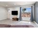 Bright living room with wood-look tile flooring, a large window, and modern decor at 9520 N Central Ave, Phoenix, AZ 85020
