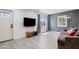 Cozy living room featuring a neutral color palette, a large window, and wood-look tile flooring at 9520 N Central Ave, Phoenix, AZ 85020