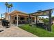 Spacious backyard featuring a covered patio with a grill, seating area, and manicured lawn at 961 Leisure World --, Mesa, AZ 85206
