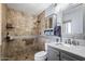 Well-lit bathroom with a tiled walk-in shower, vanity with a marble countertop, and mirrored cabinet at 961 Leisure World --, Mesa, AZ 85206