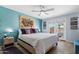 Bright bedroom featuring an accent wall, ceiling fan, and access to an outdoor patio at 961 Leisure World --, Mesa, AZ 85206