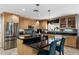 Modern kitchen with stainless steel appliances, center island with seating, and granite countertops at 961 Leisure World --, Mesa, AZ 85206