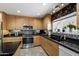 Bright kitchen featuring stainless steel oven, mosaic backsplash, and wood cabinets at 961 Leisure World --, Mesa, AZ 85206