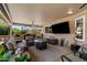 Covered outdoor patio with a comfortable seating area, TV, grill and manicured lawn at 961 Leisure World --, Mesa, AZ 85206