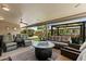 Covered outdoor patio with comfortable seating around a fire pit for cozy evenings at 961 Leisure World --, Mesa, AZ 85206