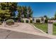 Lovely home featuring a circular driveway, desert landscaping, and green grass at 1010 E Buena Vista Dr, Tempe, AZ 85284