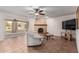 Inviting living room boasts unique fireplace, ceiling fan, and tile flooring at 1010 E Buena Vista Dr, Tempe, AZ 85284