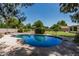 Private backyard pool surrounded by lush landscaping, offering a serene retreat for relaxation at 1010 E Buena Vista Dr, Tempe, AZ 85284