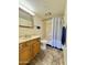 Well-lit bathroom featuring a shower-tub combo, and a neutral-toned vanity with a large mirror at 10330 W Thunderbird Blvd # C206, Sun City, AZ 85351