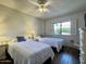 Bright bedroom with two twin beds, a ceiling fan and a window with shutter style blinds at 10330 W Thunderbird Blvd # C206, Sun City, AZ 85351