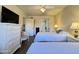 Comfortable bedroom featuring two beds, a large window, and wood look flooring at 10330 W Thunderbird Blvd # C206, Sun City, AZ 85351
