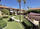 Exterior showcasing lush landscaping, walkways, community spaces with shady pergolas, and well-maintained grounds at 10330 W Thunderbird Blvd # C206, Sun City, AZ 85351