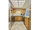 Bright kitchen features stainless steel appliances, wooden cabinetry, and a large skylight at 10330 W Thunderbird Blvd # C206, Sun City, AZ 85351