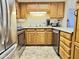 Well-lit kitchen features wooden cabinets, stainless steel appliances, and ample counter space at 10330 W Thunderbird Blvd # C206, Sun City, AZ 85351