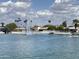 Scenic lake view with a fountain, waterfront homes, palm trees, and boats under a partly cloudy sky at 10330 W Thunderbird Blvd # C206, Sun City, AZ 85351