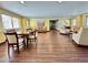 Bright living area featuring wood flooring, neutral paint, and comfortable seating arrangements at 10330 W Thunderbird Blvd # C206, Sun City, AZ 85351
