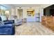 Open concept living room with wooden floors and kitchen view at 10330 W Thunderbird Blvd # C206, Sun City, AZ 85351