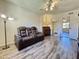 Bright living room featuring an updated ceiling fan, laminate flooring, and a comfortable reclining sofa at 10330 W Thunderbird Blvd # C206, Sun City, AZ 85351
